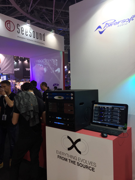 Powersoft area at a trade show: amplifier rack and a computer with control software, next to the SeeSound booth