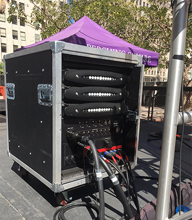 Rack case with three Powersoft X8 amplifiers and cabling beside the Pershing Square stage