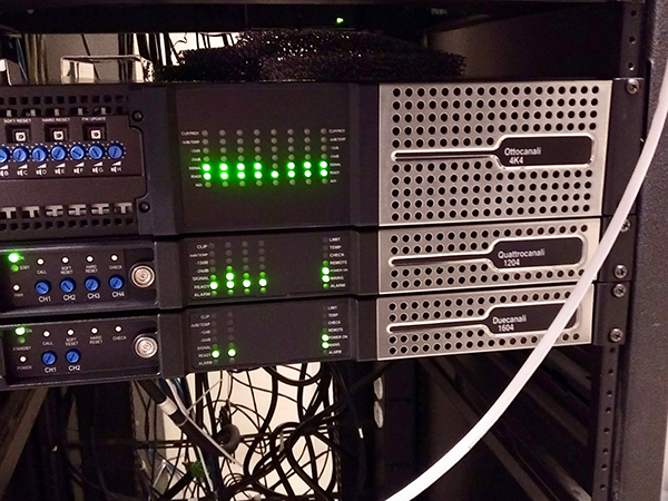 Rack with Ottocanali 4K4, Quattrocanali 1204 and Duecanali 1604 amplifiers, green LEDs lit