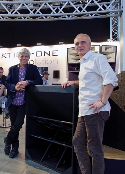 Two men beside a large bass loudspeaker at the Funktion-One trade show booth
