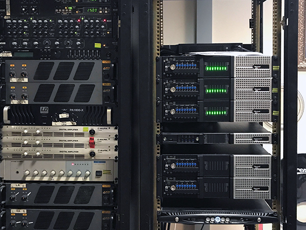 Two racks: third-party amplifiers on the left, Powersoft multichannel amplifiers and an X Series unit on the right