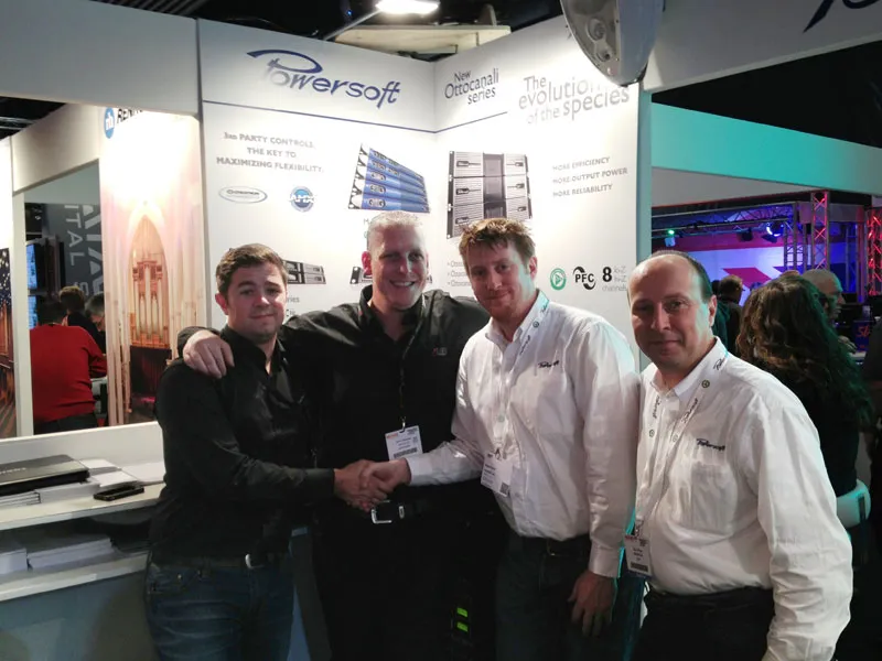 Four men at the Powersoft trade show booth, two of them shaking hands