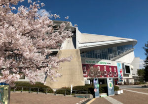 Noevir Stadium exterior with a cherry tree in bloom in the foreground
