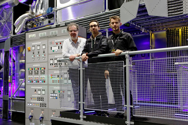From left, Bobby Aitken, Luis Miranda and Scott Willsallen by a control panel on the Dinosaurs in the Wild set