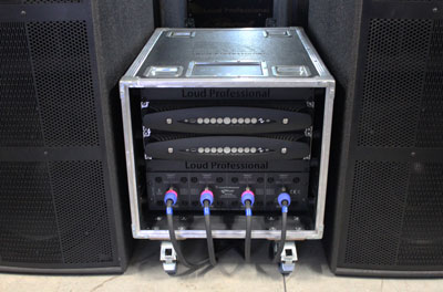 Loud Professional rack case with two Powersoft X8 amplifiers between two loudspeaker cabinets