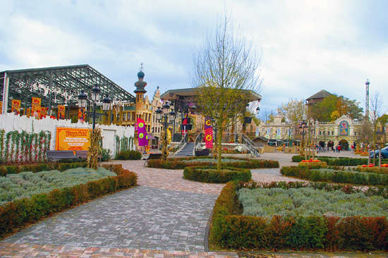 Main square of Plopsaland with the bandstand, paved paths and hedged flower beds