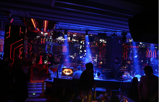 Ningbo EVER Club interior with a crowd, DJ booth and red and blue lighting