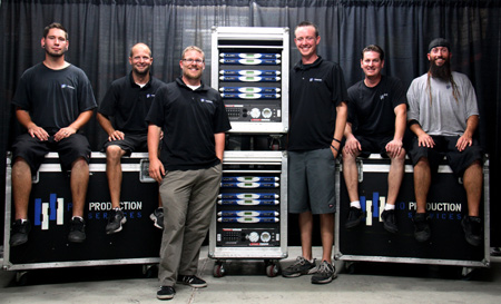 Pro Production Services team with road cases and a stacked rack of Powersoft K Series amplifiers