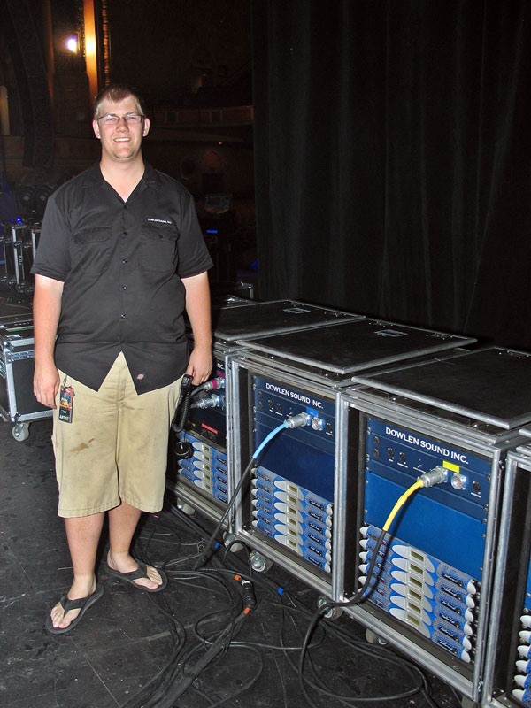Eric Satre next to Dowlen Sound Inc. amplifier racks with Powersoft K Series amplifiers