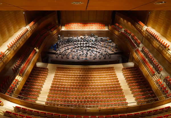Queen Elisabeth Hall in Antwerp: auditorium with orange seats and the stage set for an orchestra