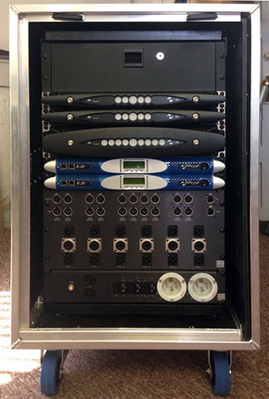 Rack case with Powersoft X4, X8 and K20 amplifiers above connector panels