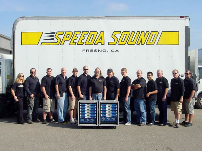Speeda Sound crew in front of the company truck, with two racks of Powersoft amplifiers