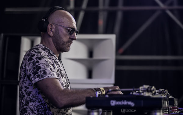 Sven Väth at the turntables at Kappa FuturFestival, with a white horn loudspeaker behind