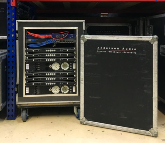 Anderson Audio rack case with six Powersoft X4 amplifiers and a network switch, lid beside it