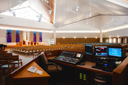 Mixing station in the sanctuary of St. Andrew Lutheran Church, with a digital console and monitors