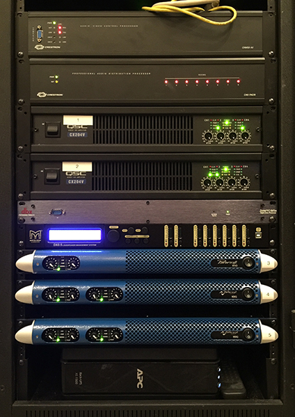 Rack with Crestron processors, two QSC amplifiers and Powersoft M50Q, M28Q and M14D amplifiers