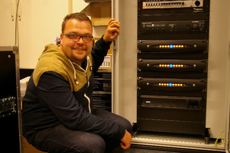 Bart van der Smissen beside a rack with three Powersoft X8 amplifiers