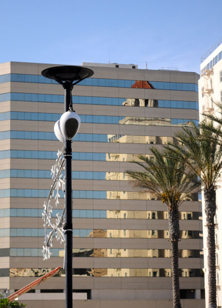Lamp post with two Deva units in front of an office building and palm trees