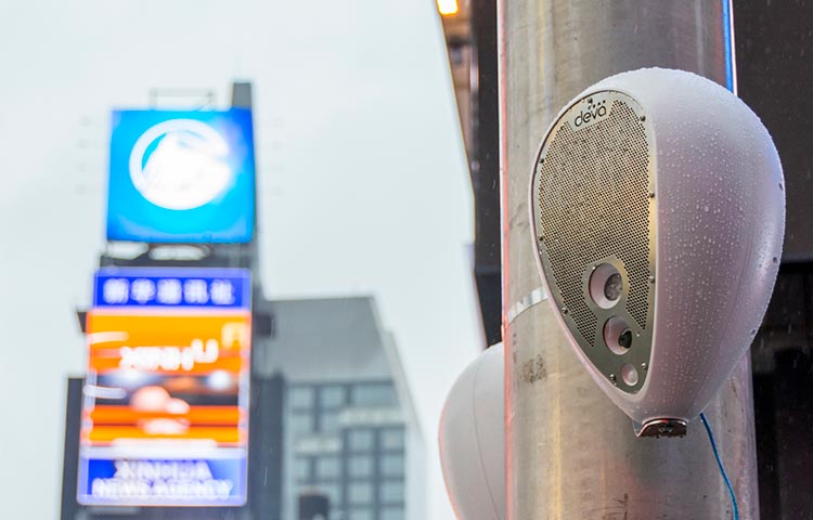 Deva unit on a light pole in Times Square, covered in raindrops