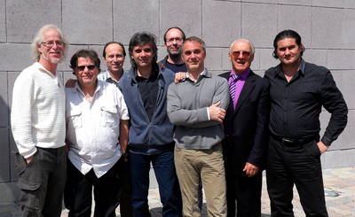 Eight Powersoft U.S. and Powersoft Global managers posing against a stone wall