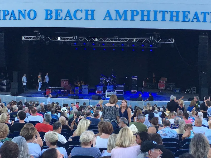 Audience seated in front of the stage at Pompano Beach Amphitheater before the show