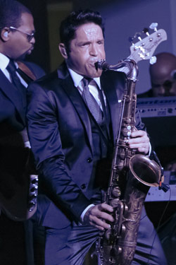Dave Koz playing saxophone on stage at Spaghettini