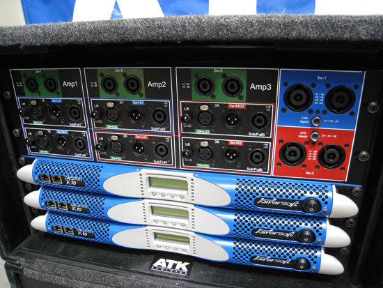 ATK touring rack with three blue K10 amplifiers under a connector panel labelled Amp1, Amp2 and Amp3