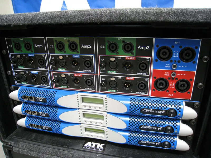Front of an ATK Audiotek amp rack: connector panel above three Powersoft DIGAM K10 amplifiers