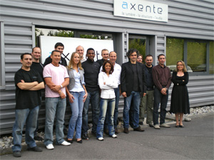 Axente team posing outside the Axente office building
