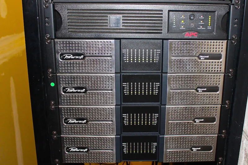 Rack with an APC UPS above four Powersoft Ottocanali 8K4 amplifiers